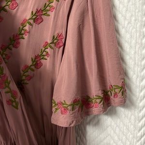 Mauve wrap dress. Embroidery around sleeves and chest.